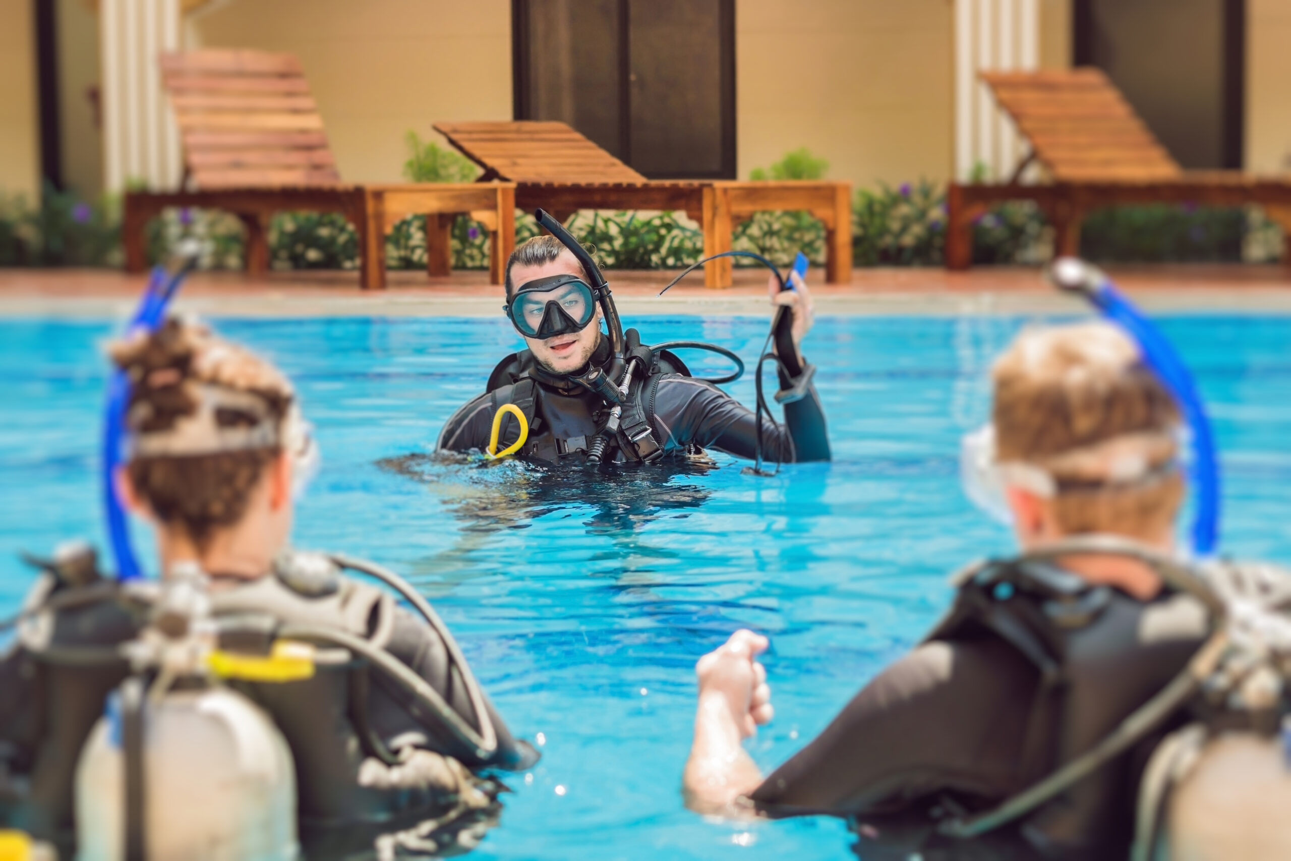 Diving instructor and students. Instructor teaches students to dive.